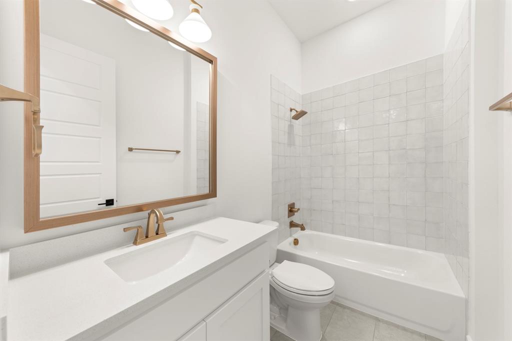 4711 Belo Drive Prosper, TX 75078 - Photo 16 of 40 a bathroom with a sink a toilet and shower