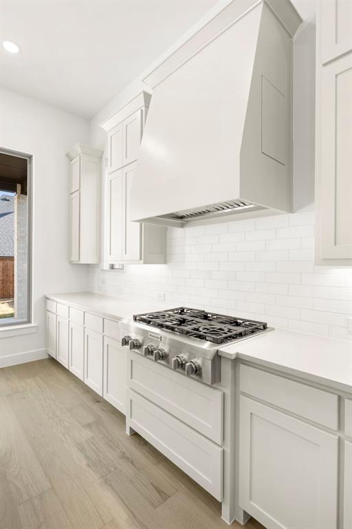 4711 Belo Drive Prosper, TX 75078 - Photo 27 of 40 a kitchen with granite countertop white cabinets and a stove