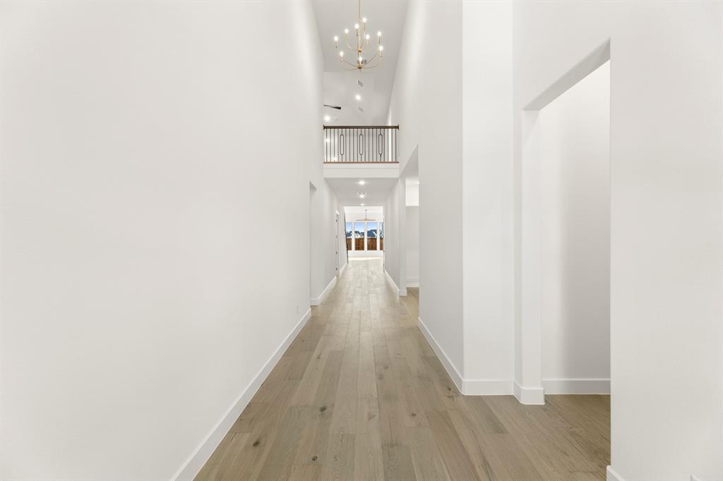 4711 Belo Drive Prosper, TX 75078 - Photo 4 of 40 a view of a hallway with wooden floor and staircase