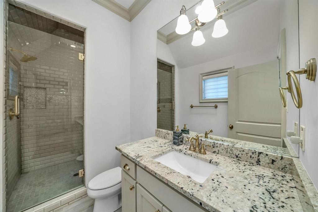12114 Prestonridge Road Dallas, TX 75230 - Photo 38 of 40 Bathroom featuring a frameless glass shower enclosure with subway tile surround, built-in shower niche, and a rain showerhead