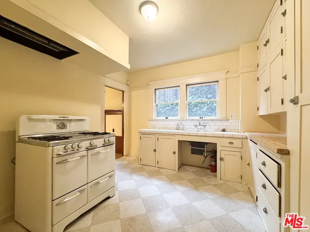 a kitchen with a stove oven and sink