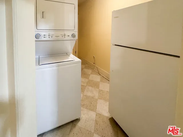 a view of a house with a large windows and flower plants