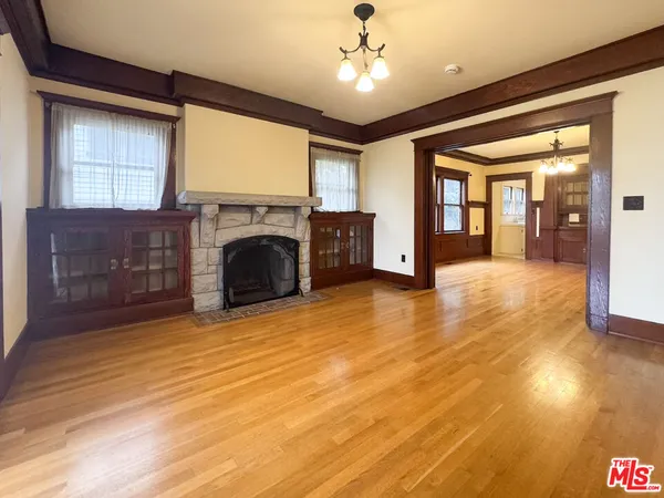 a view of a livingroom with a fireplace and window