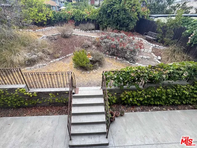 a view of stairs and yard with green space