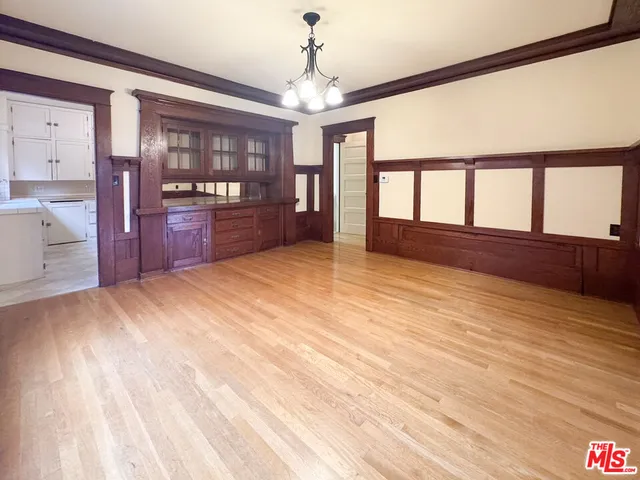 a view of empty room with a fireplace and windows