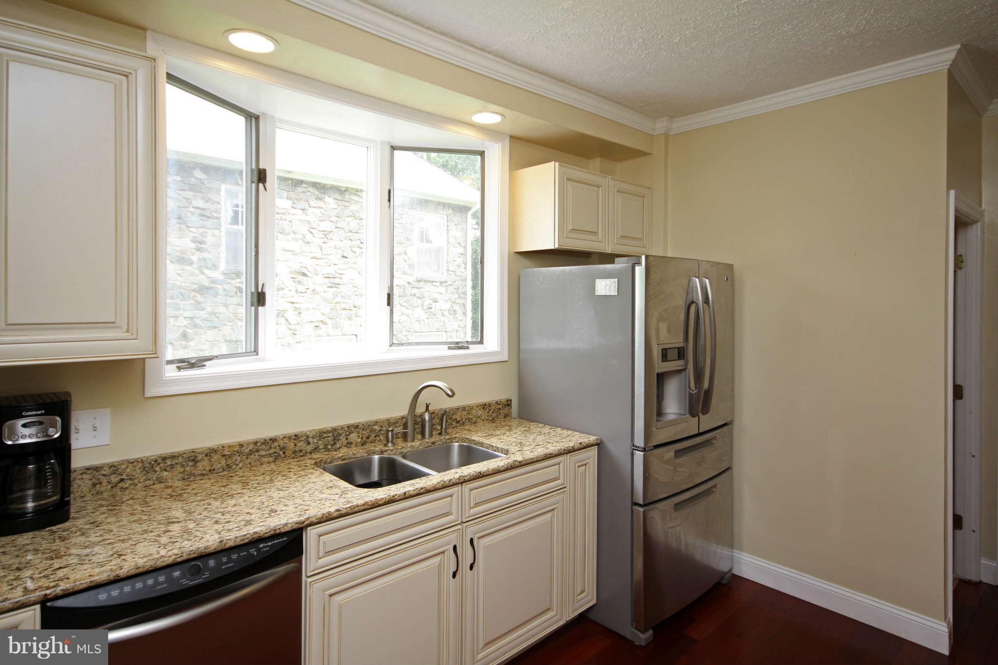 603 Academy Road Baltimore, MD 21228 - Photo 6 of 30 a kitchen with stainless steel appliances granite countertop a refrigerator sink and cabinets