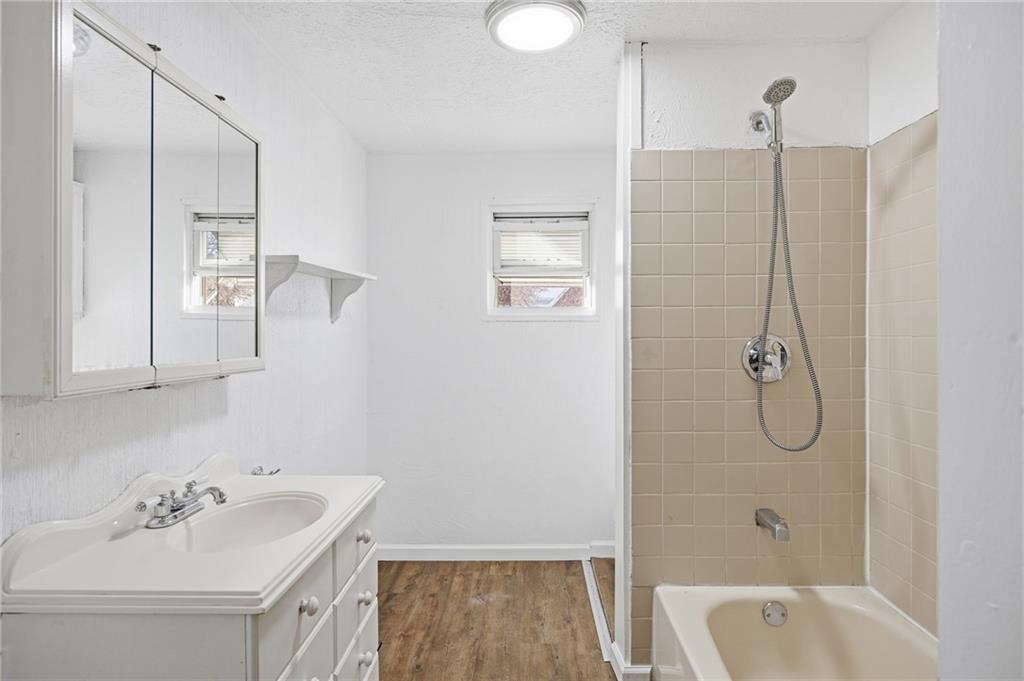 212 Comrie Avenue Braddock, PA 15104 - Photo 13 of 18 a bathroom with a tub sink and mirror