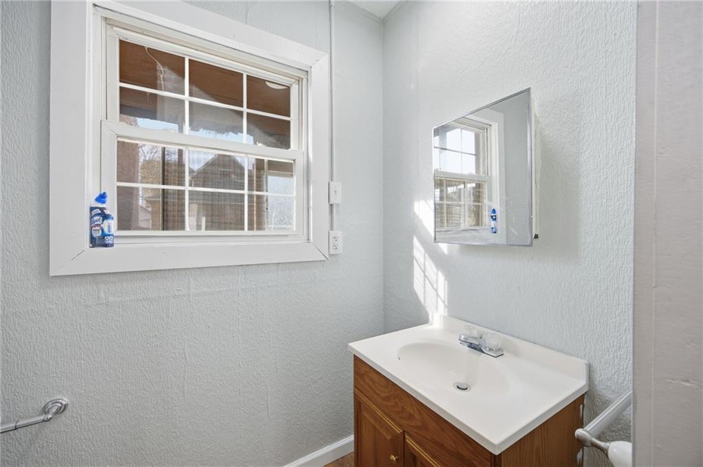 212 Comrie Avenue Braddock, PA 15104 - Photo 16 of 18 a bathroom with a sink a vanity and a window