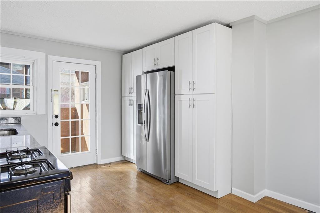 212 Comrie Avenue Braddock, PA 15104 - Photo 3 of 18 a kitchen with stainless steel appliances granite countertop a refrigerator and a stove