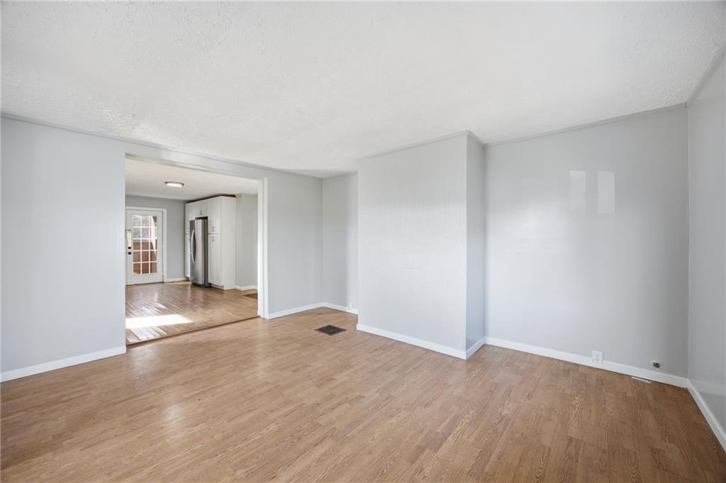 212 Comrie Avenue Braddock, PA 15104 - Photo 6 of 18 a view of empty room with wooden floor