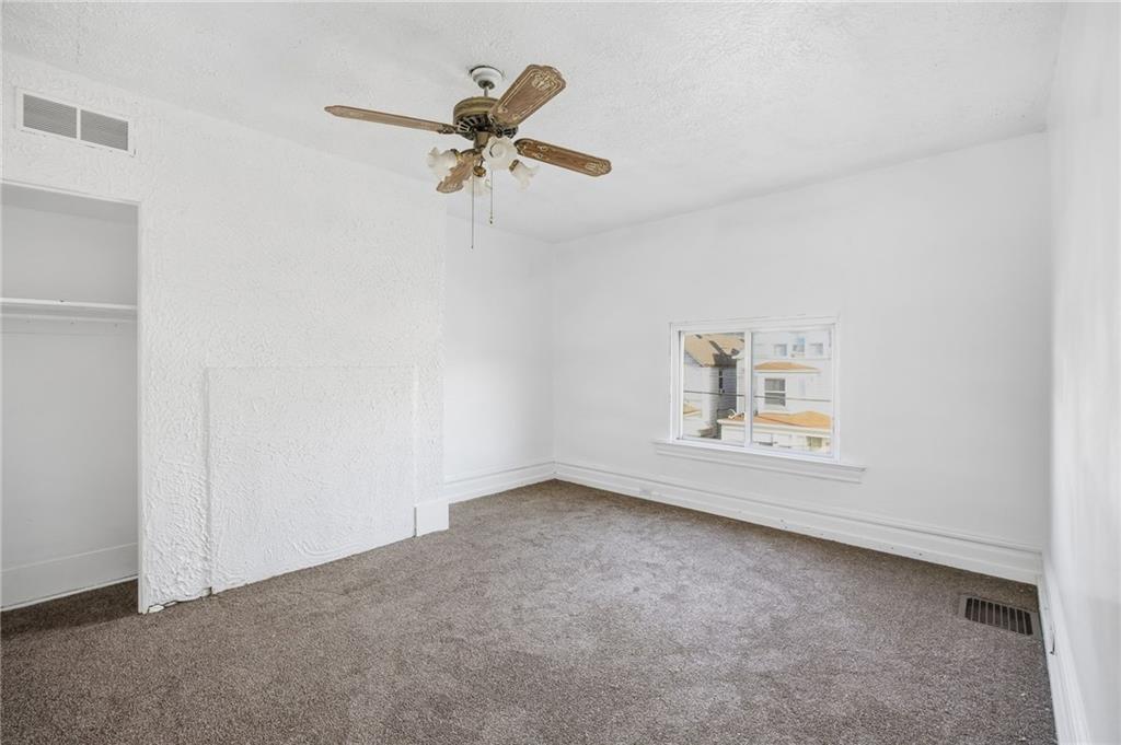 212 Comrie Avenue Braddock, PA 15104 - Photo 7 of 18 an empty room with a window and ceiling fan