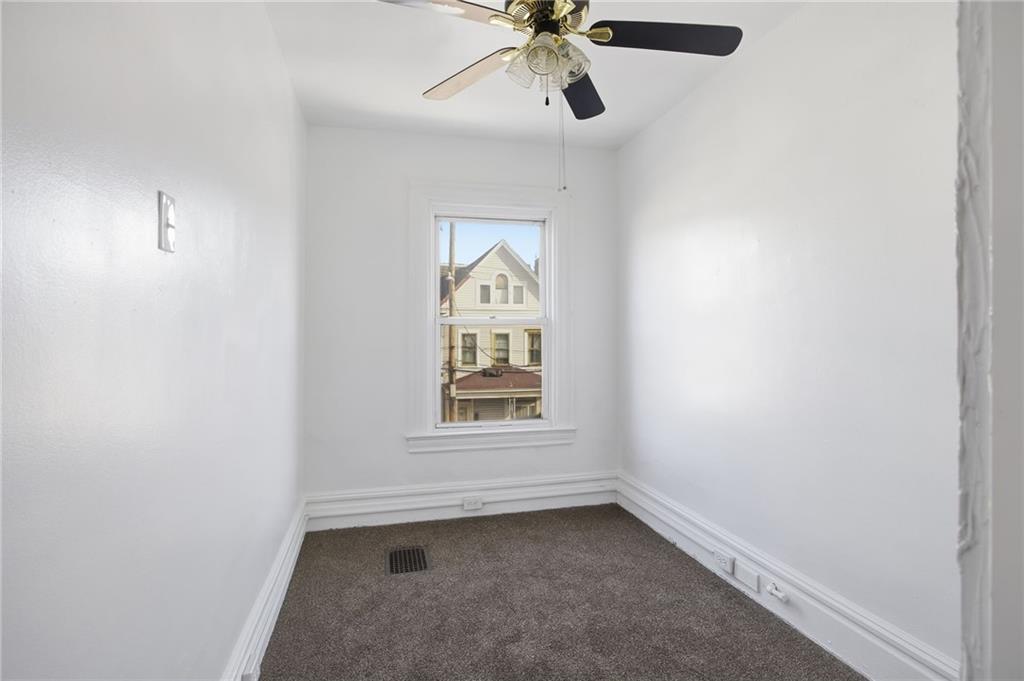 212 Comrie Avenue Braddock, PA 15104 - Photo 10 of 18 an empty room with a window and a fan