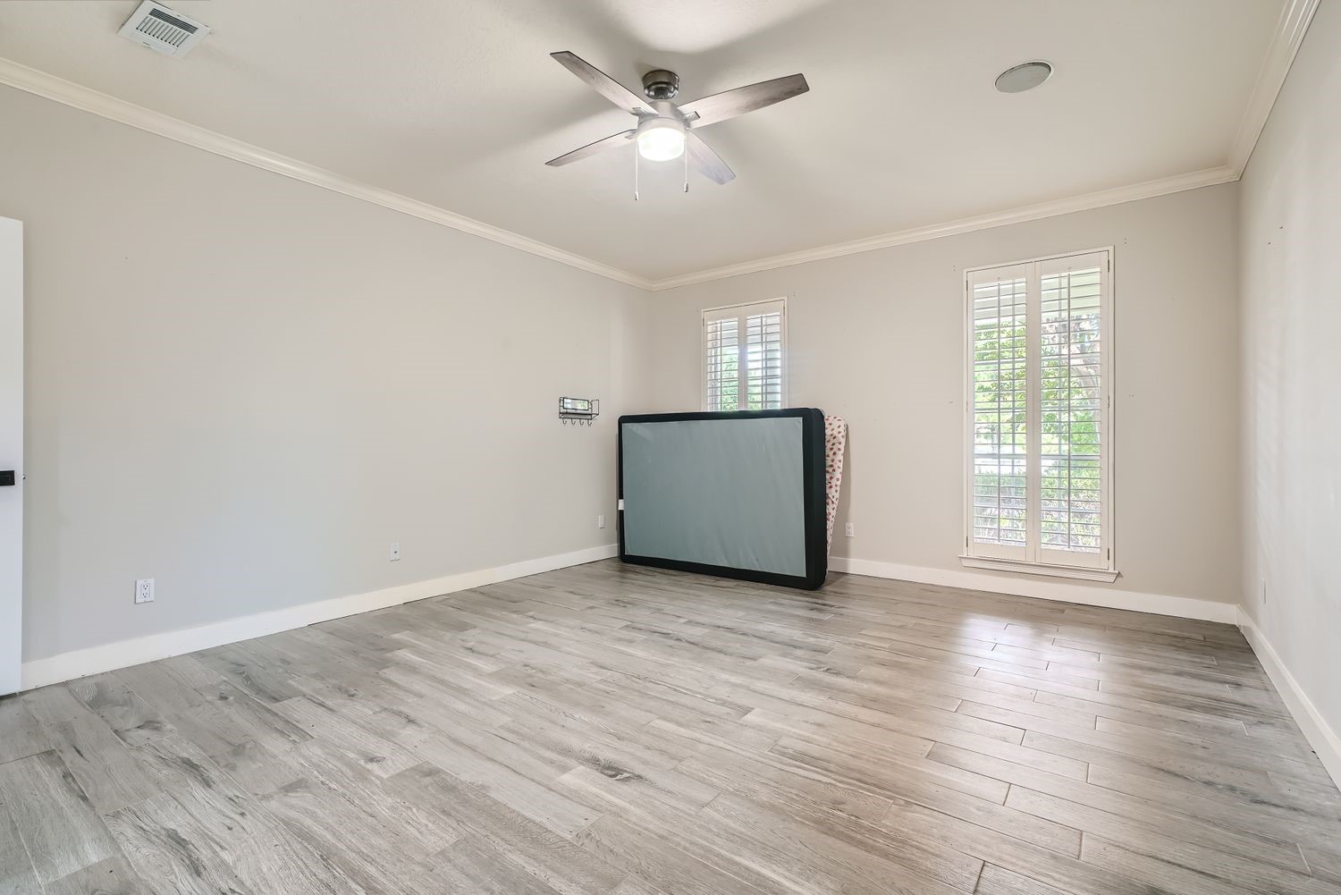 17 Leandro Court Montgomery, TX 77356 - Photo 19 of 38 an empty room with wooden floor and windows