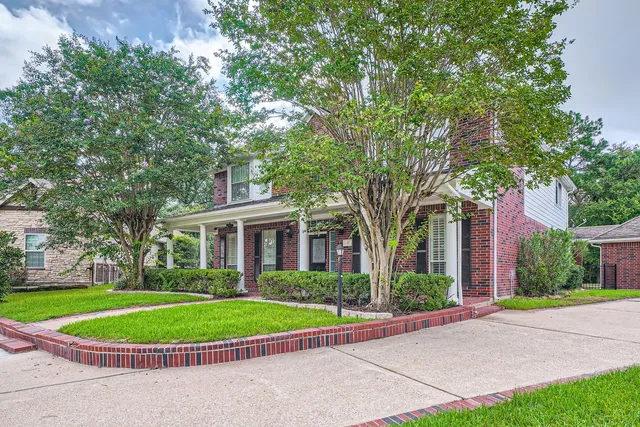 front view of a house with a garden