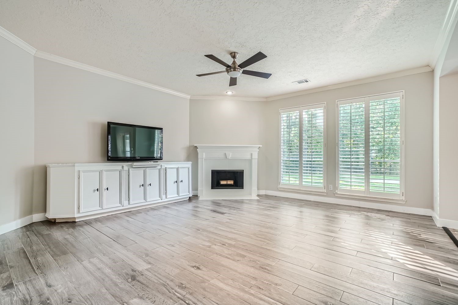 17 Leandro Court Montgomery, TX 77356 - Photo 5 of 38 wooden floor fireplace and windows in an empty room