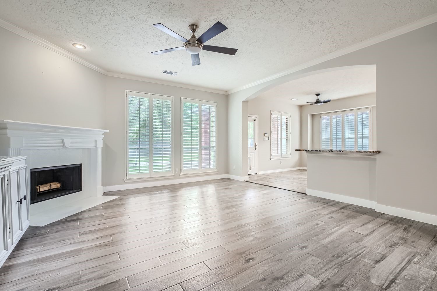 17 Leandro Court Montgomery, TX 77356 - Photo 8 of 38 an empty room with wooden floor fireplace and windows