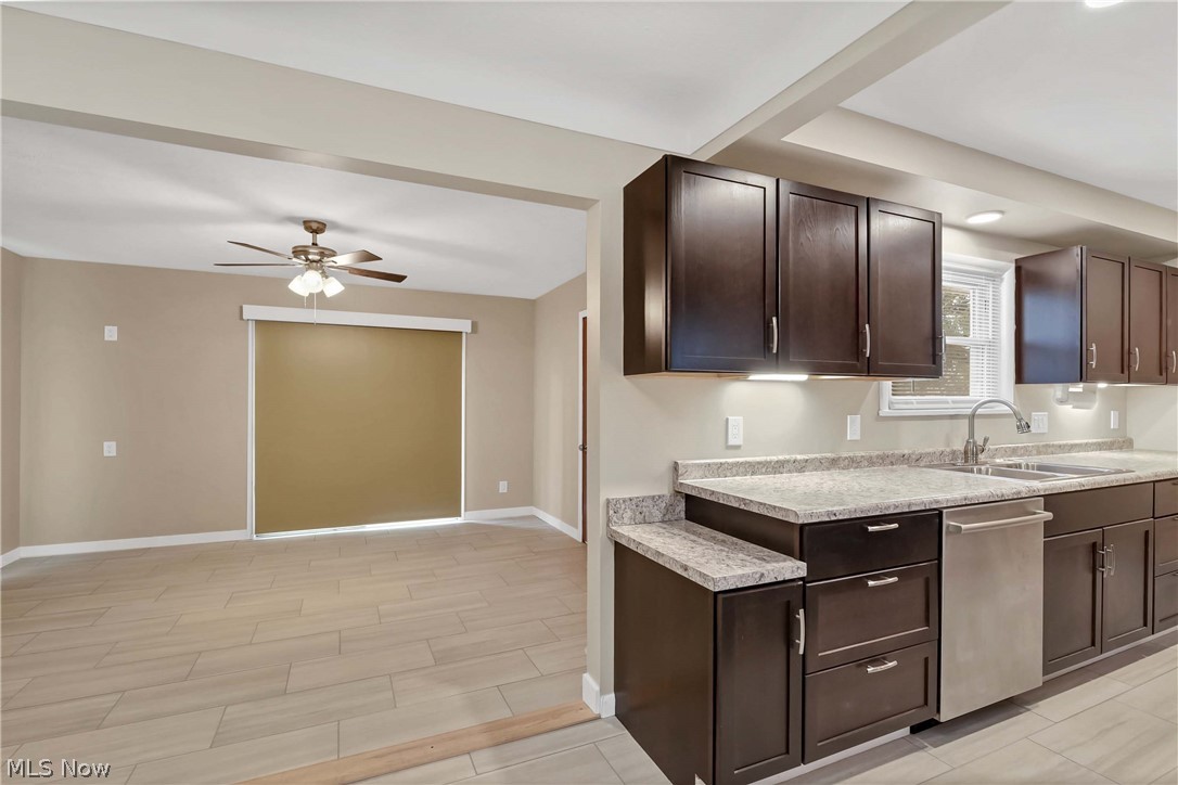 7528 State Road Parma, OH 44129 - Photo 15 of 40 Kitchen with dark brown cabinets, dishwasher, sink, and ceiling fan