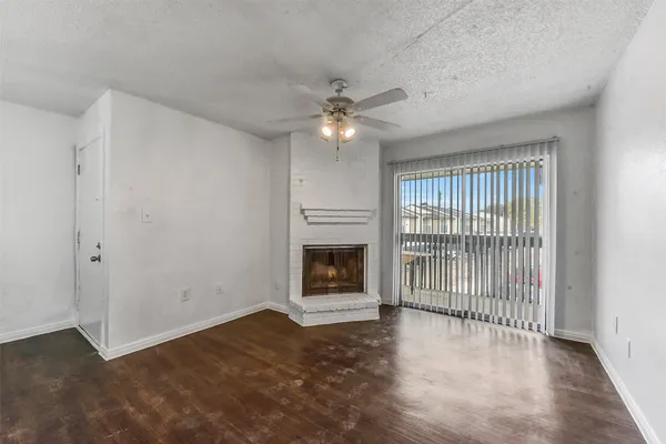 wooden floor in an empty room with a fireplace