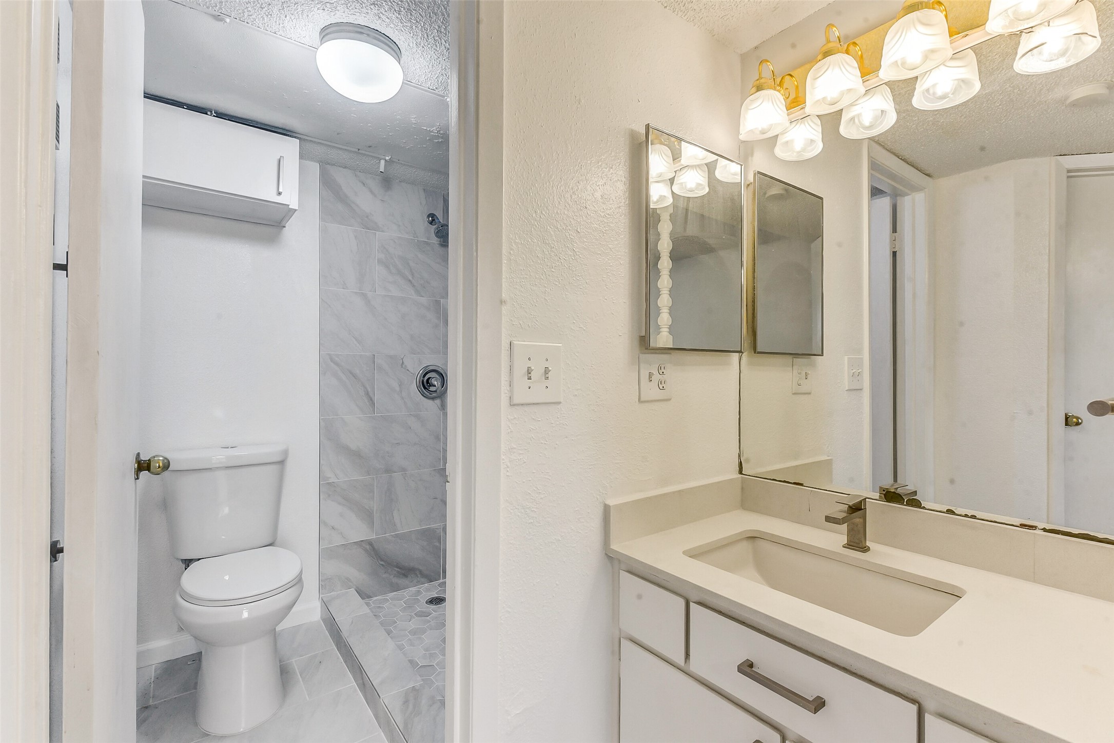 250 El Dorado Boulevard, Unit 248 Webster, TX 77598 - Photo 11 of 16 a bathroom with a sink a toilet and a mirror