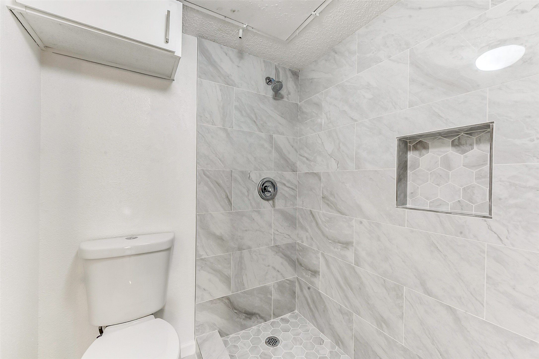 250 El Dorado Boulevard, Unit 248 Webster, TX 77598 - Photo 12 of 16 a bathroom with a toilet and a shower