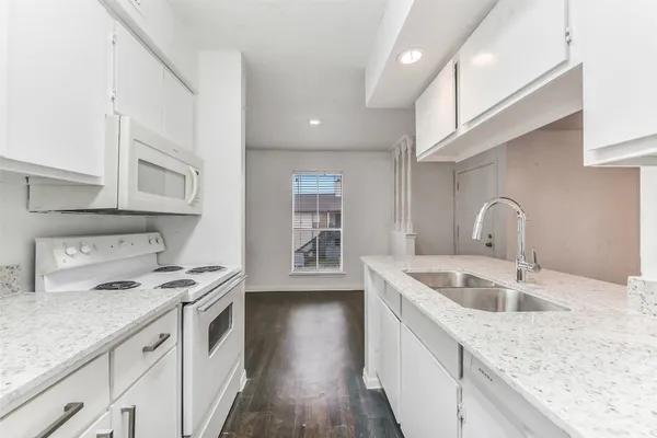 a kitchen with stainless steel appliances granite countertop a sink stove and cabinets