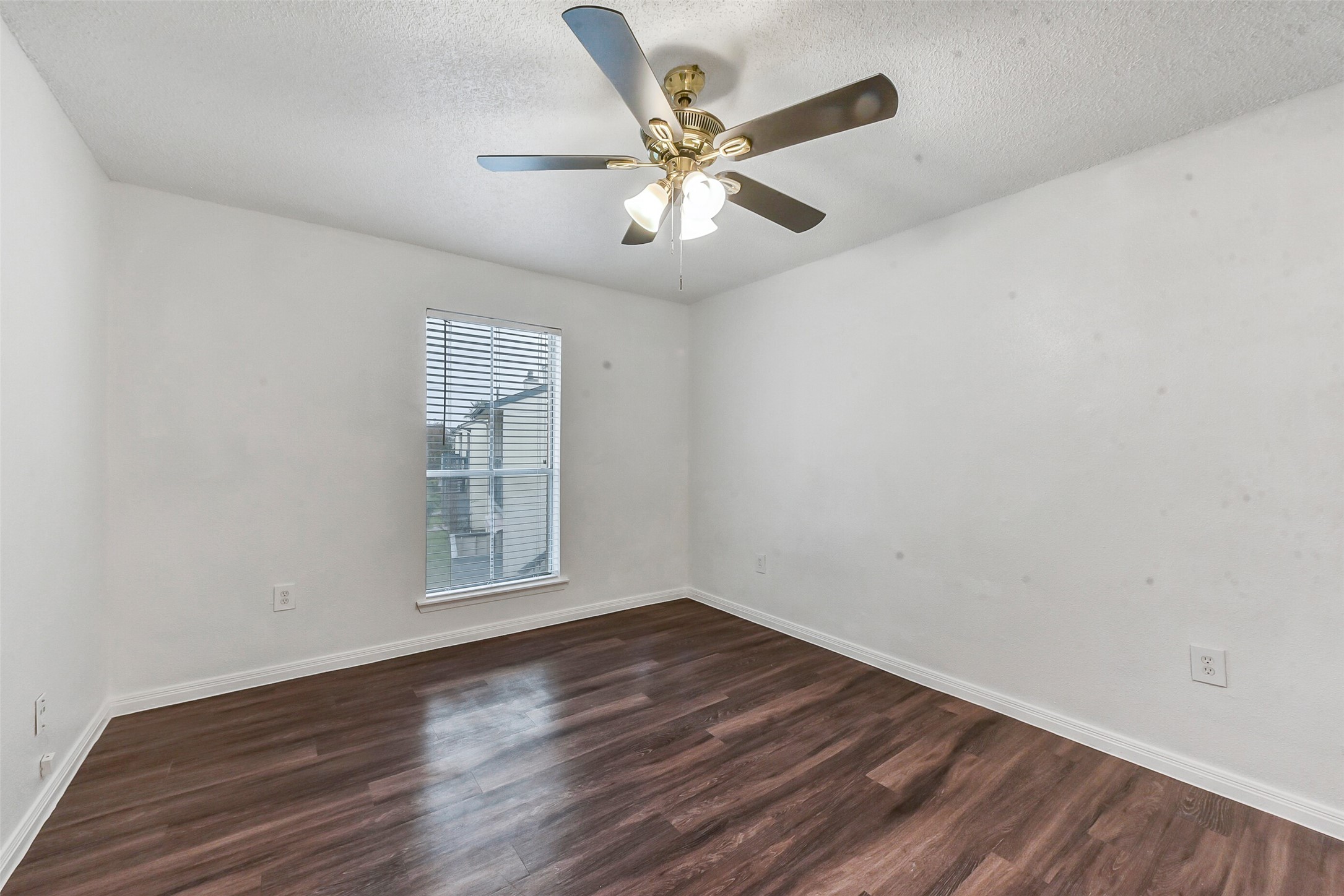 250 El Dorado Boulevard, Unit 248 Webster, TX 77598 - Photo 9 of 16 an empty room with wooden floor ceiling fan and windows