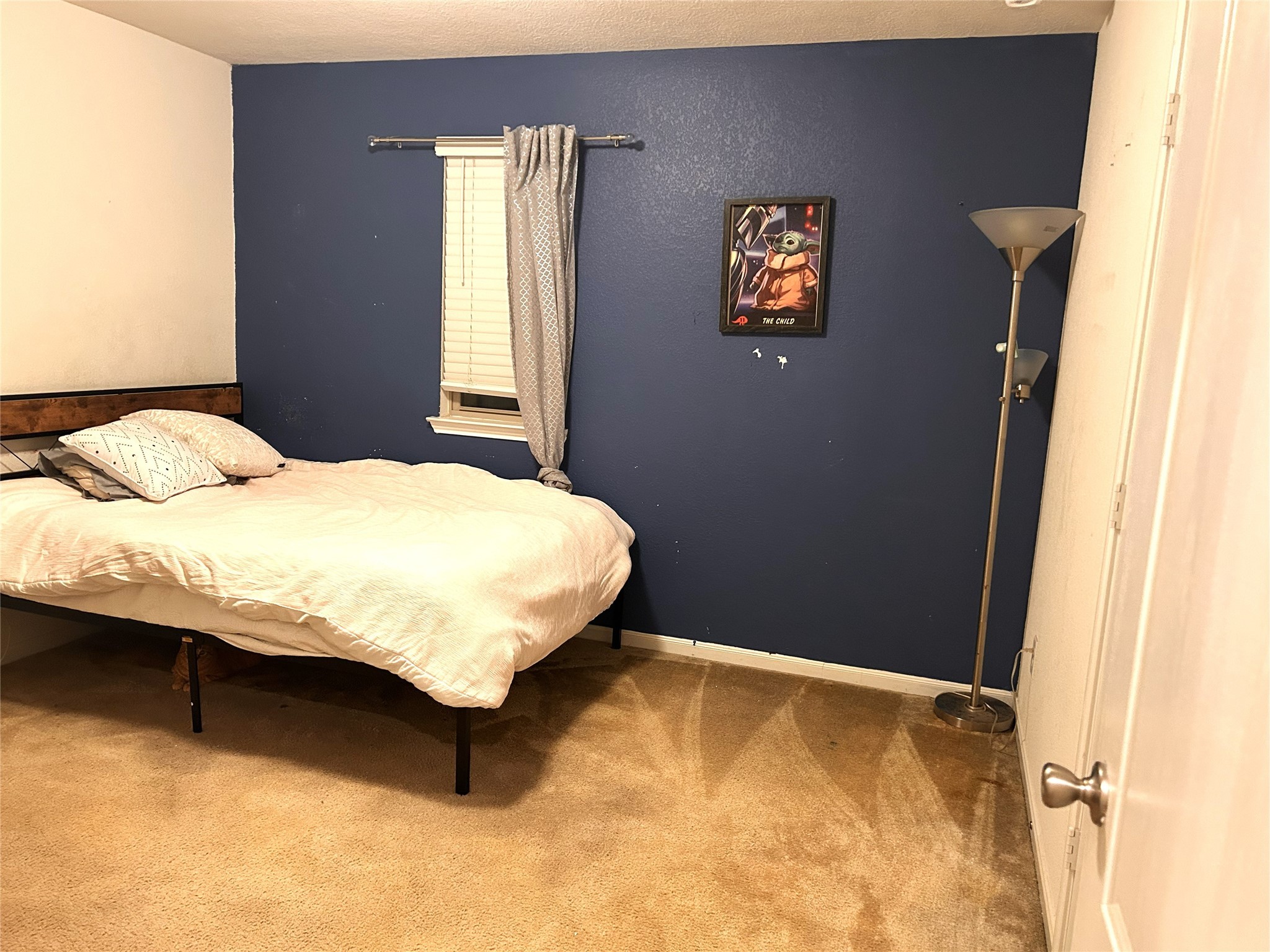 9839 Mills Field Drive Houston, TX 77070 - Photo 14 of 19 a bedroom with a bed and window