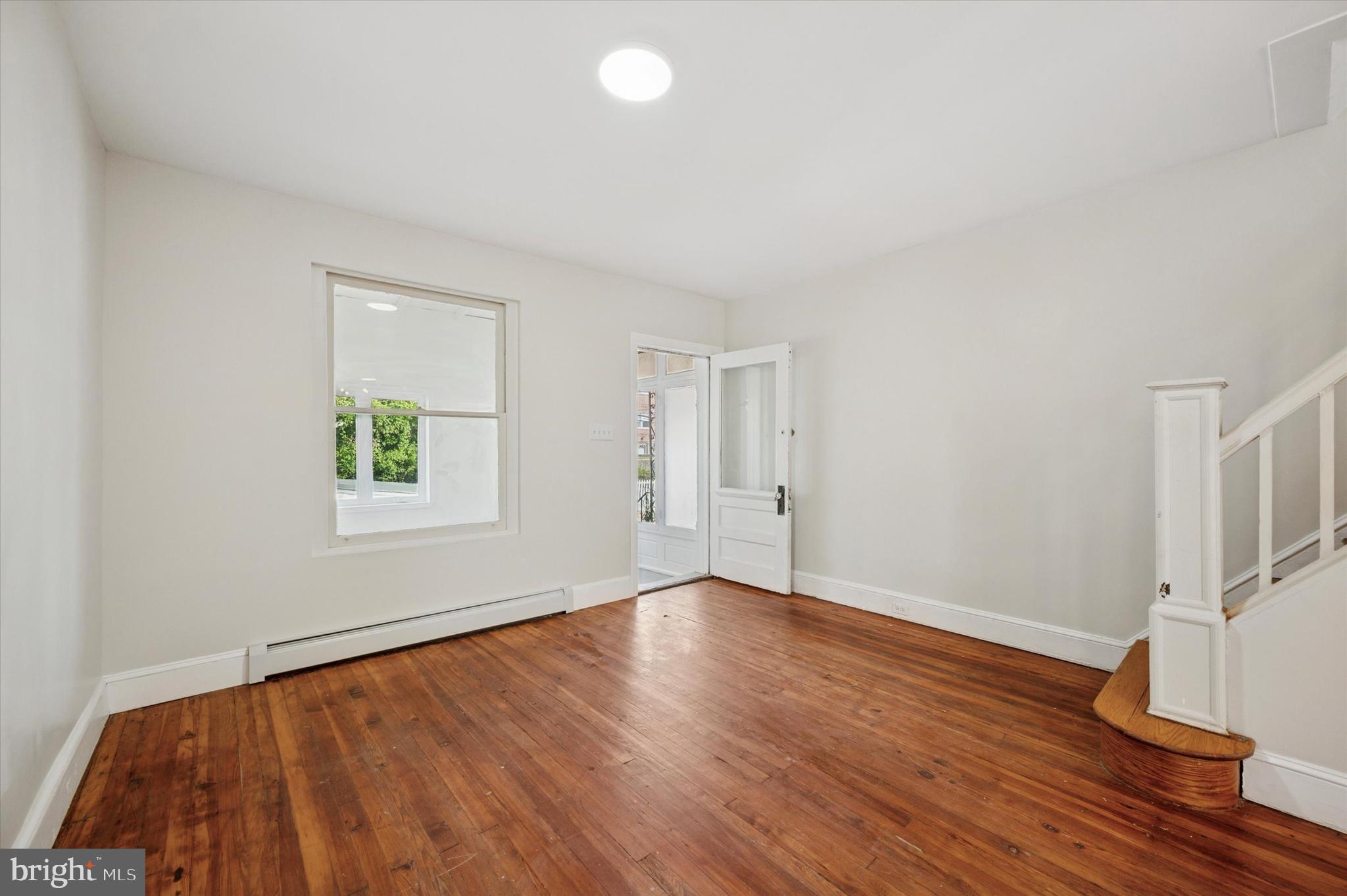 610 Martin Street Philadelphia, PA 19128 - Photo 4 of 24 an empty room with wooden floor and windows