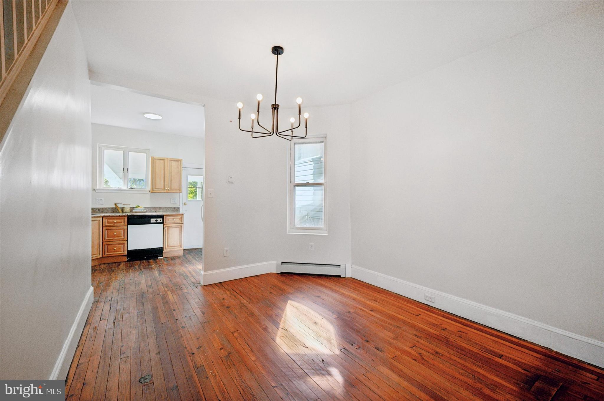 610 Martin Street Philadelphia, PA 19128 - Photo 9 of 24 a view of empty room with wooden floor and kitchen view