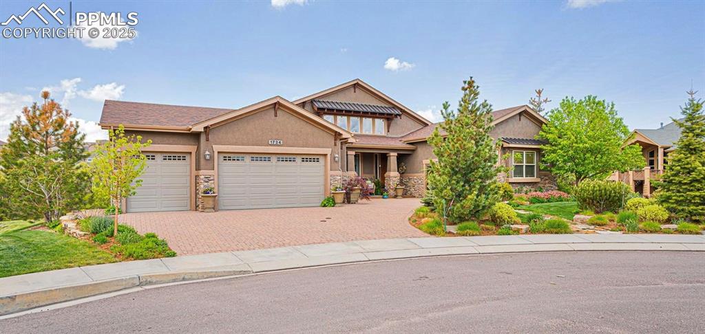 a front view of a house with a yard and a garage