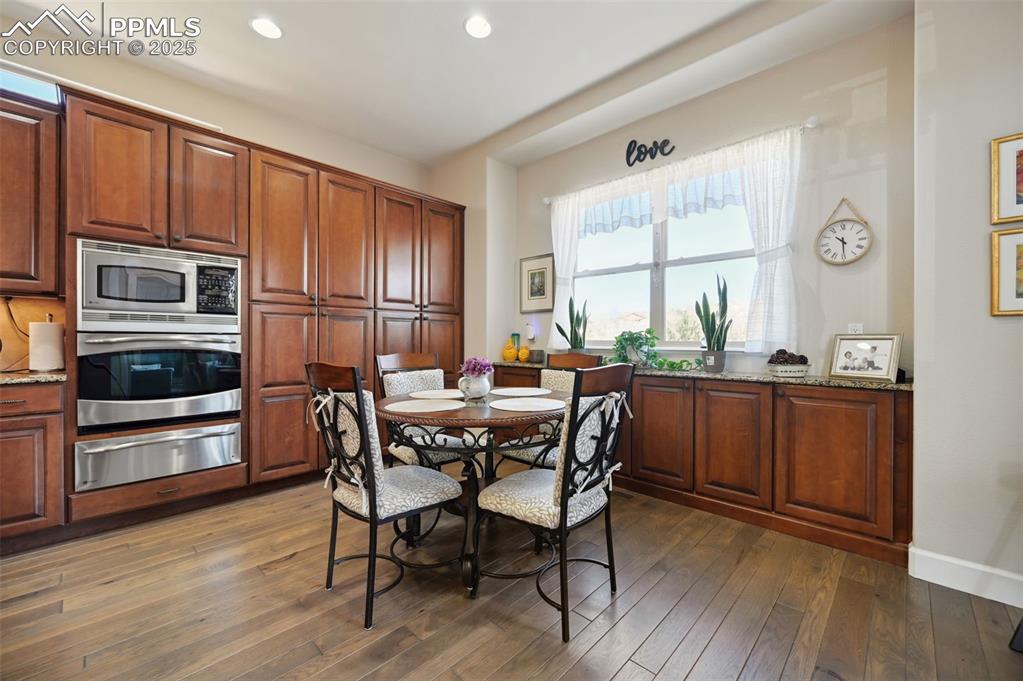 1724 Valley Stream Court Colorado Springs, CO 80921 - Photo 11 of 49 a view of a dining room with furniture window and wooden floor