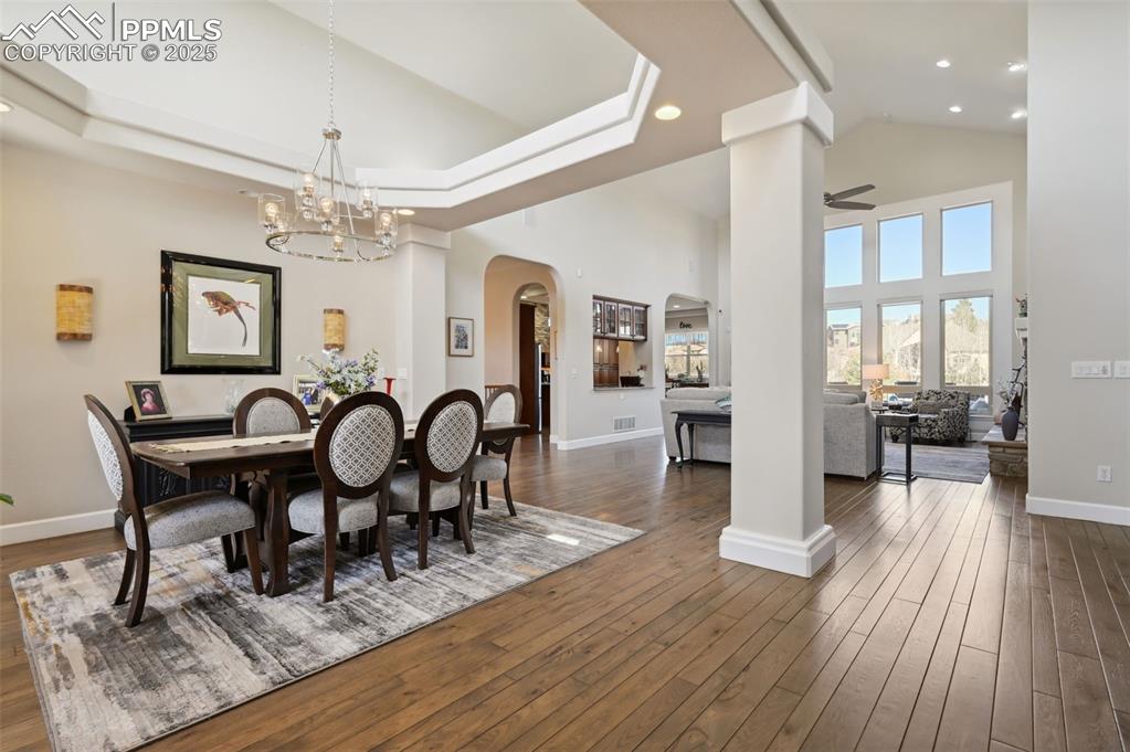 1724 Valley Stream Court Colorado Springs, CO 80921 - Photo 2 of 49 a view of a dining room with furniture a chandelier and wooden floor