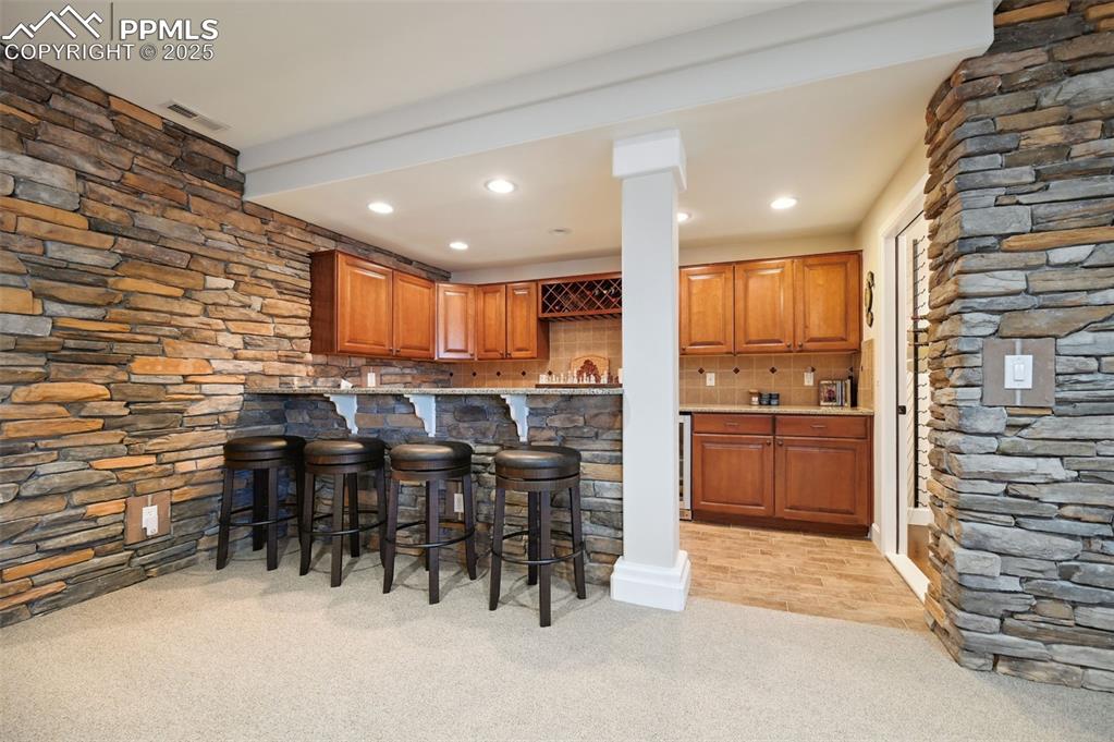 1724 Valley Stream Court Colorado Springs, CO 80921 - Photo 27 of 49 a kitchen with furniture a refrigerator and a sink