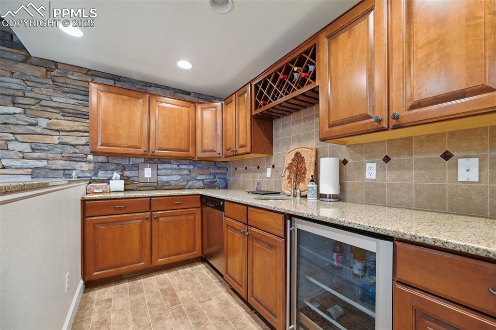 1724 Valley Stream Court Colorado Springs, CO 80921 - Photo 29 of 49 a kitchen with stainless steel appliances granite countertop a sink and cabinets