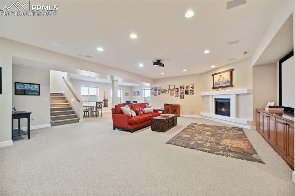 1724 Valley Stream Court Colorado Springs, CO 80921 - Photo 30 of 49 a spacious bedroom with furniture and a fireplace