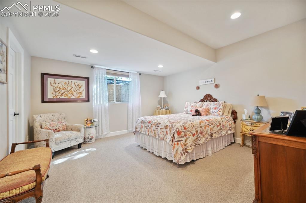 1724 Valley Stream Court Colorado Springs, CO 80921 - Photo 36 of 49 a bedroom with a bed couch and a window