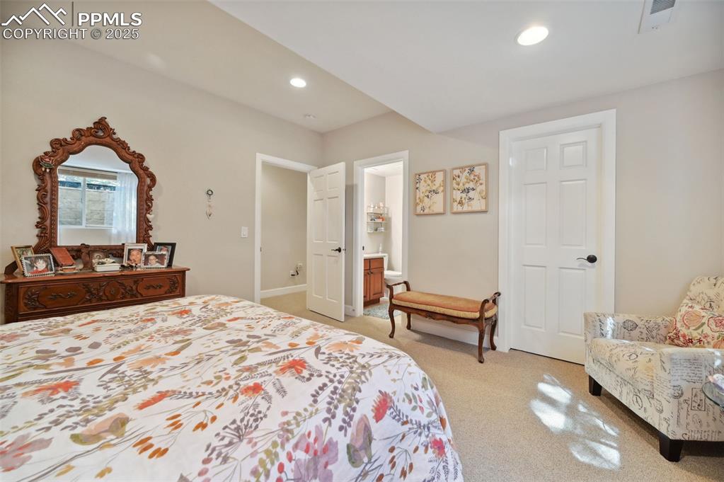1724 Valley Stream Court Colorado Springs, CO 80921 - Photo 37 of 49 a spacious bedroom with a bed and a dresser in it
