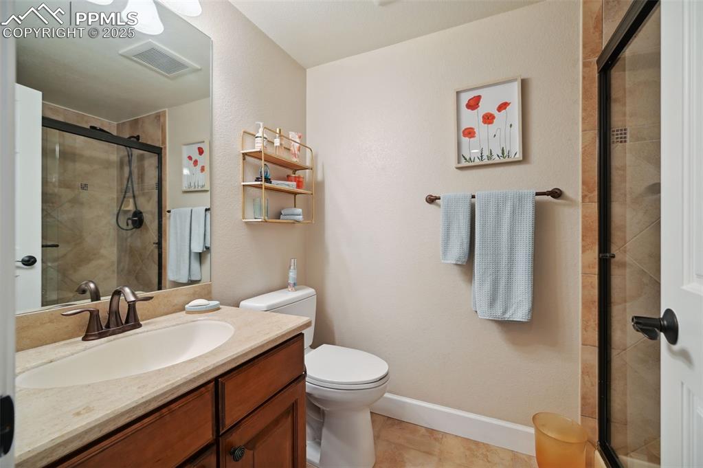 1724 Valley Stream Court Colorado Springs, CO 80921 - Photo 38 of 49 a bathroom with a sink a toilet and a mirror