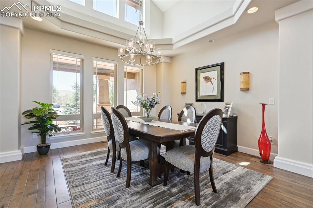 1724 Valley Stream Court Colorado Springs, CO 80921 - Photo 6 of 49 a view of a dining room with furniture wooden floor and a chandelier