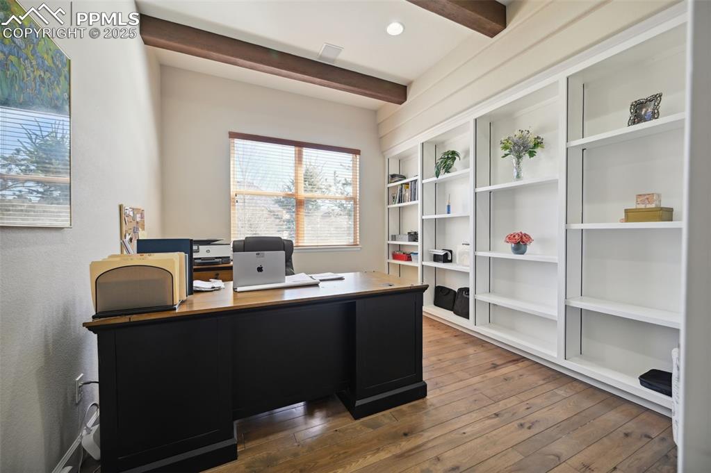 1724 Valley Stream Court Colorado Springs, CO 80921 - Photo 7 of 49 a view of a workspace with furniture and wooden floor