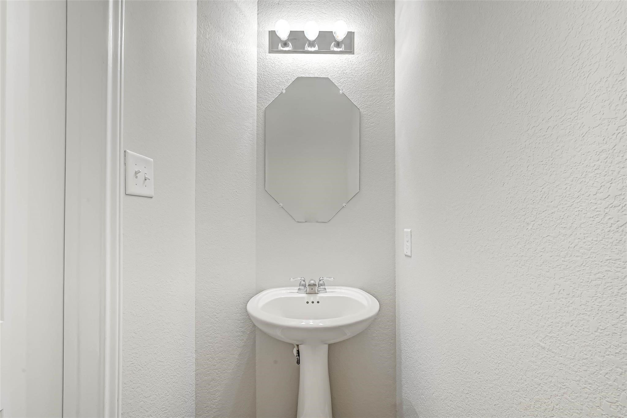 18606 Lansdowne Stream Path Katy, TX 77449 - Photo 18 of 39 a bathroom with a sink and a mirror