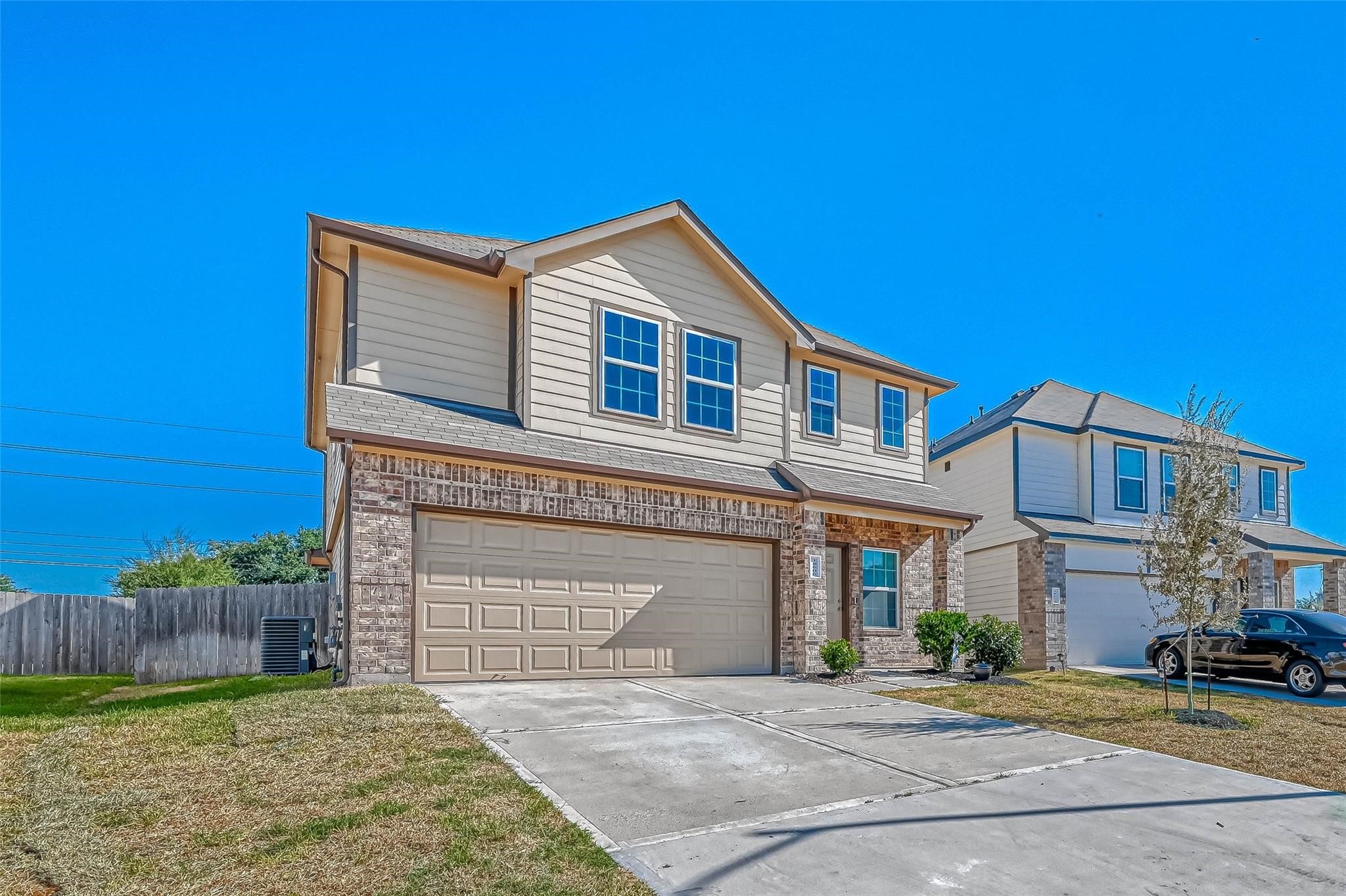 18606 Lansdowne Stream Path Katy, TX 77449 - Photo 2 of 39 a front view of a house with a yard and garage