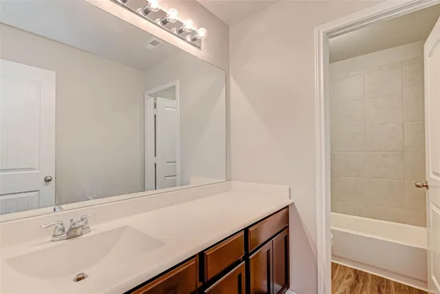 a white bath tub sitting next to a white toilet and sink