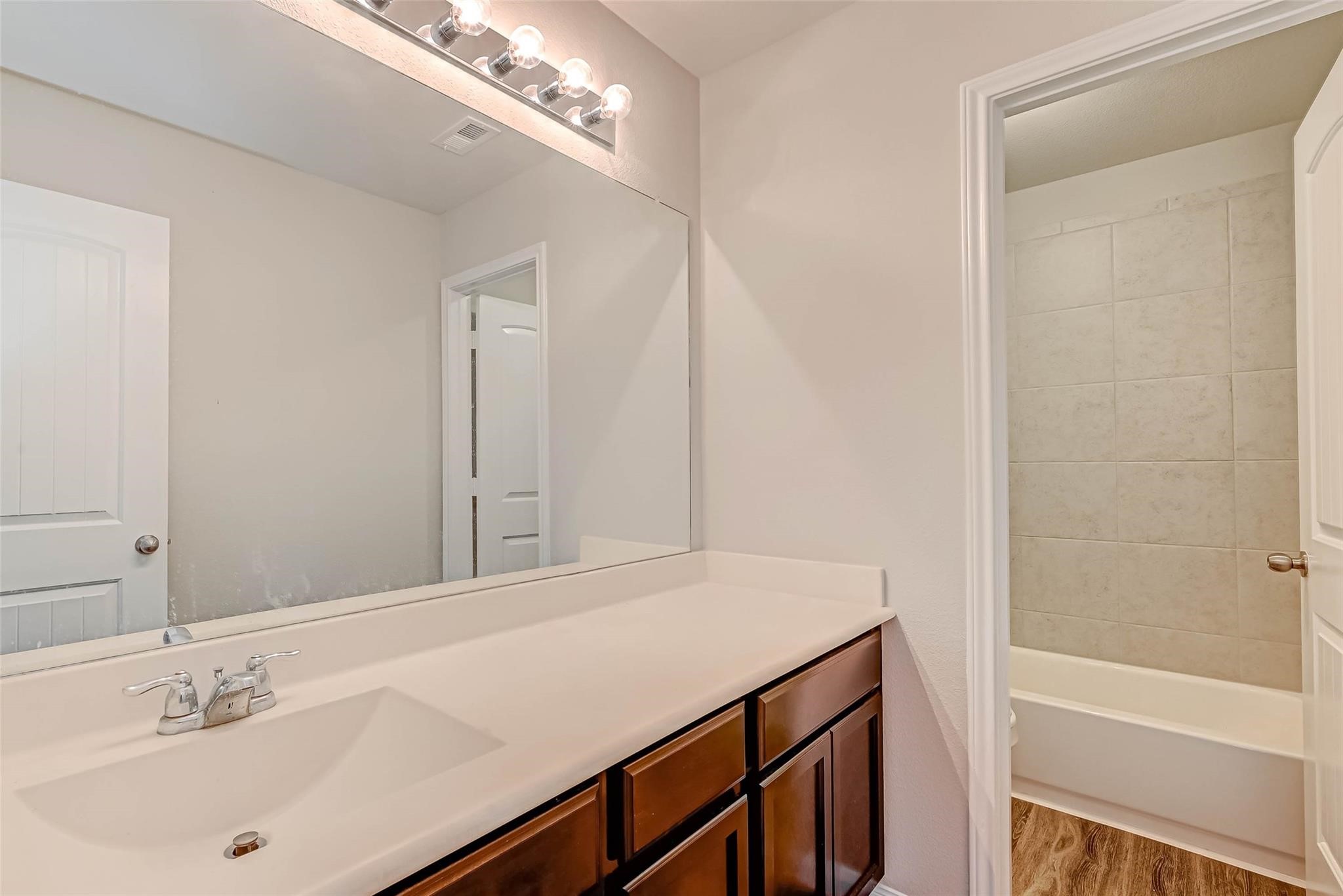 18606 Lansdowne Stream Path Katy, TX 77449 - Photo 21 of 39 a bathroom with a sink a shower and a mirror
