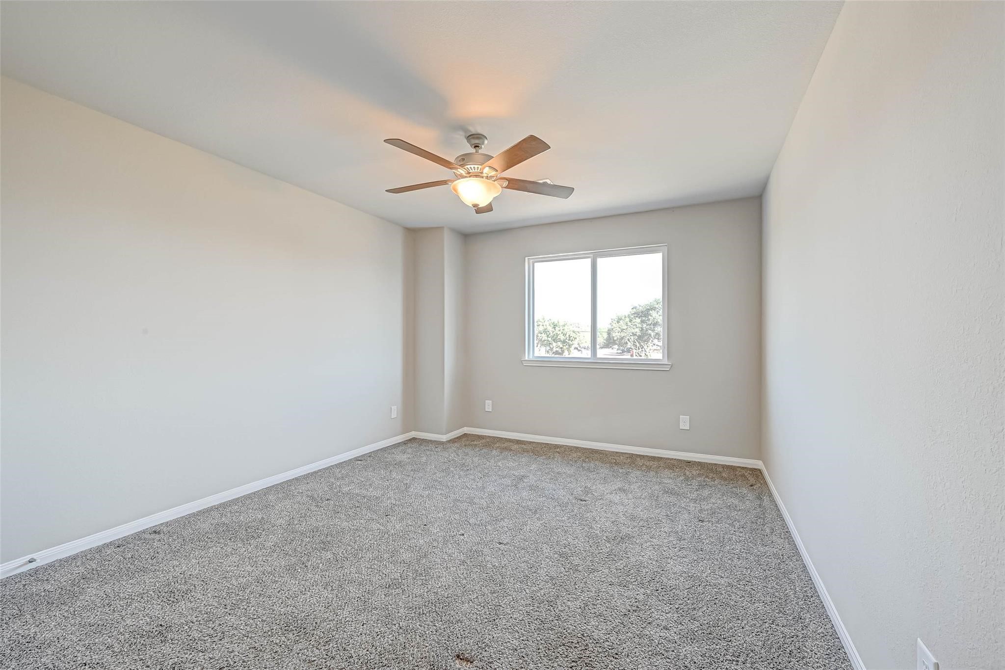 18606 Lansdowne Stream Path Katy, TX 77449 - Photo 23 of 39 an empty room with a window and a ceiling fan