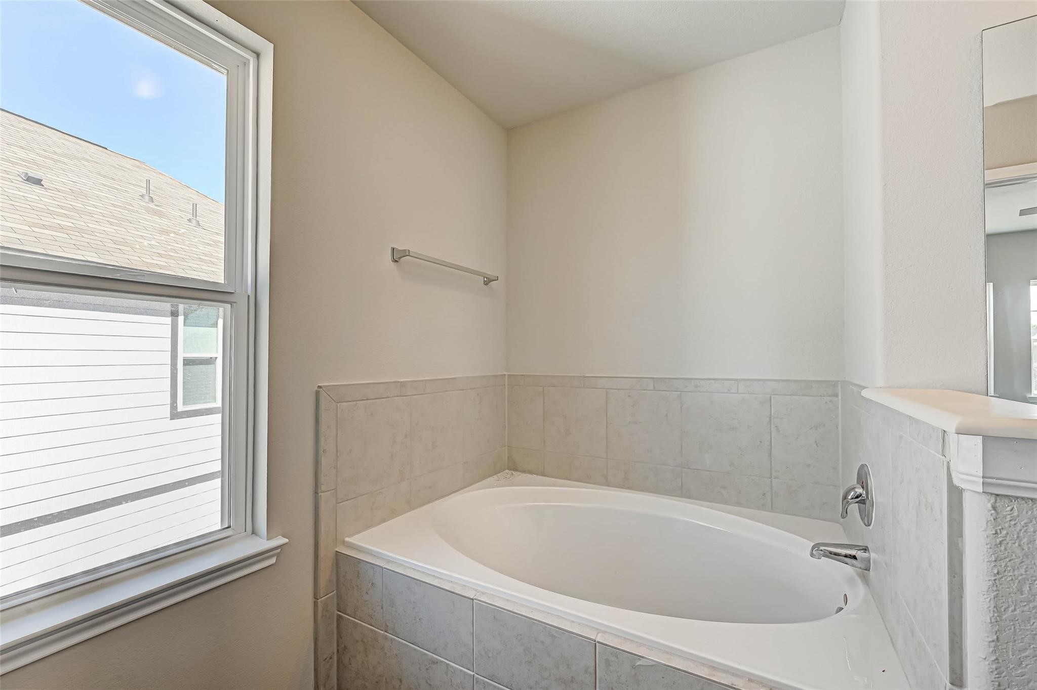 18606 Lansdowne Stream Path Katy, TX 77449 - Photo 30 of 39 a white bath tub sitting next to a window