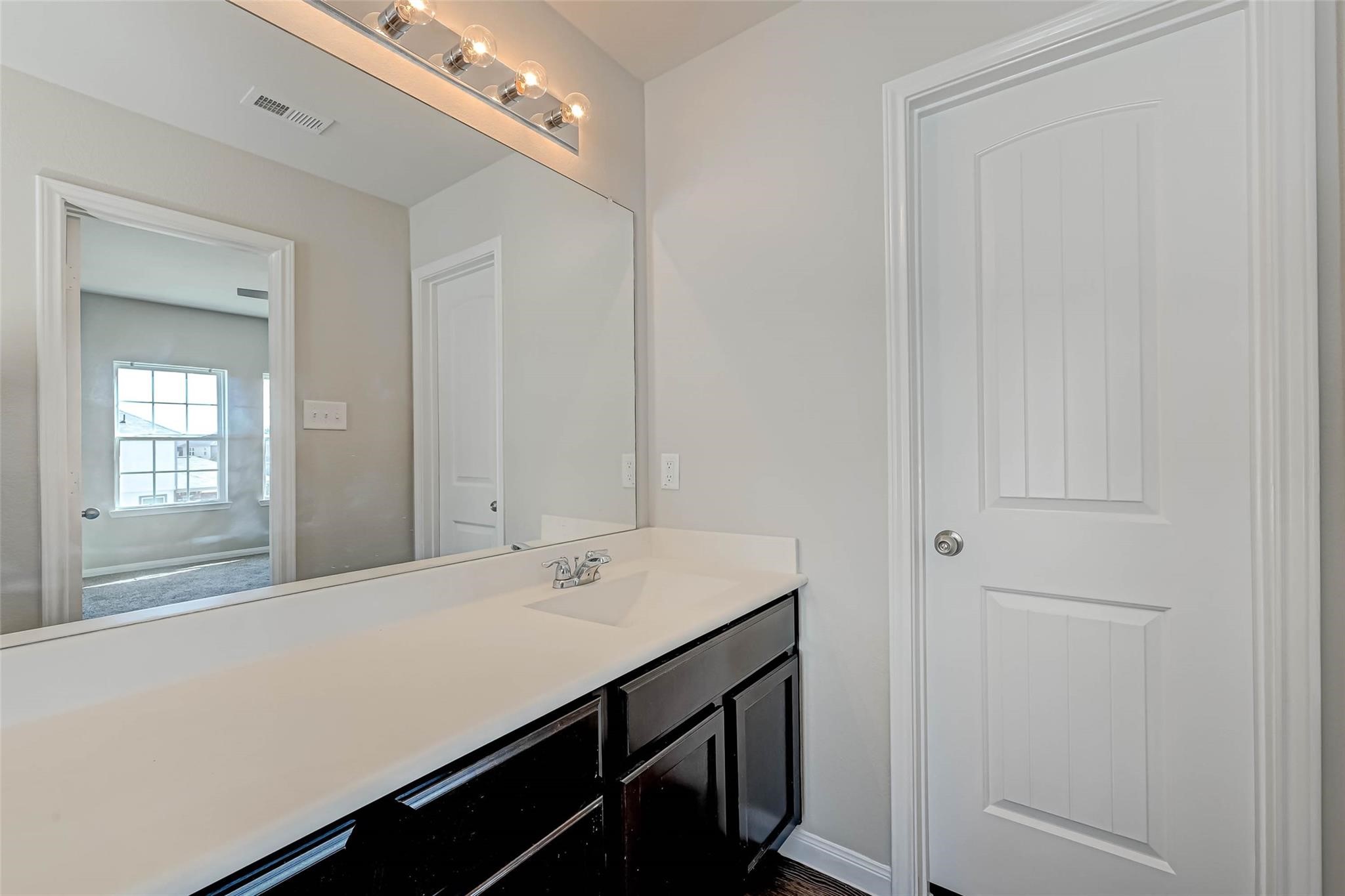 18606 Lansdowne Stream Path Katy, TX 77449 - Photo 31 of 39 a bathroom with a sink and a mirror