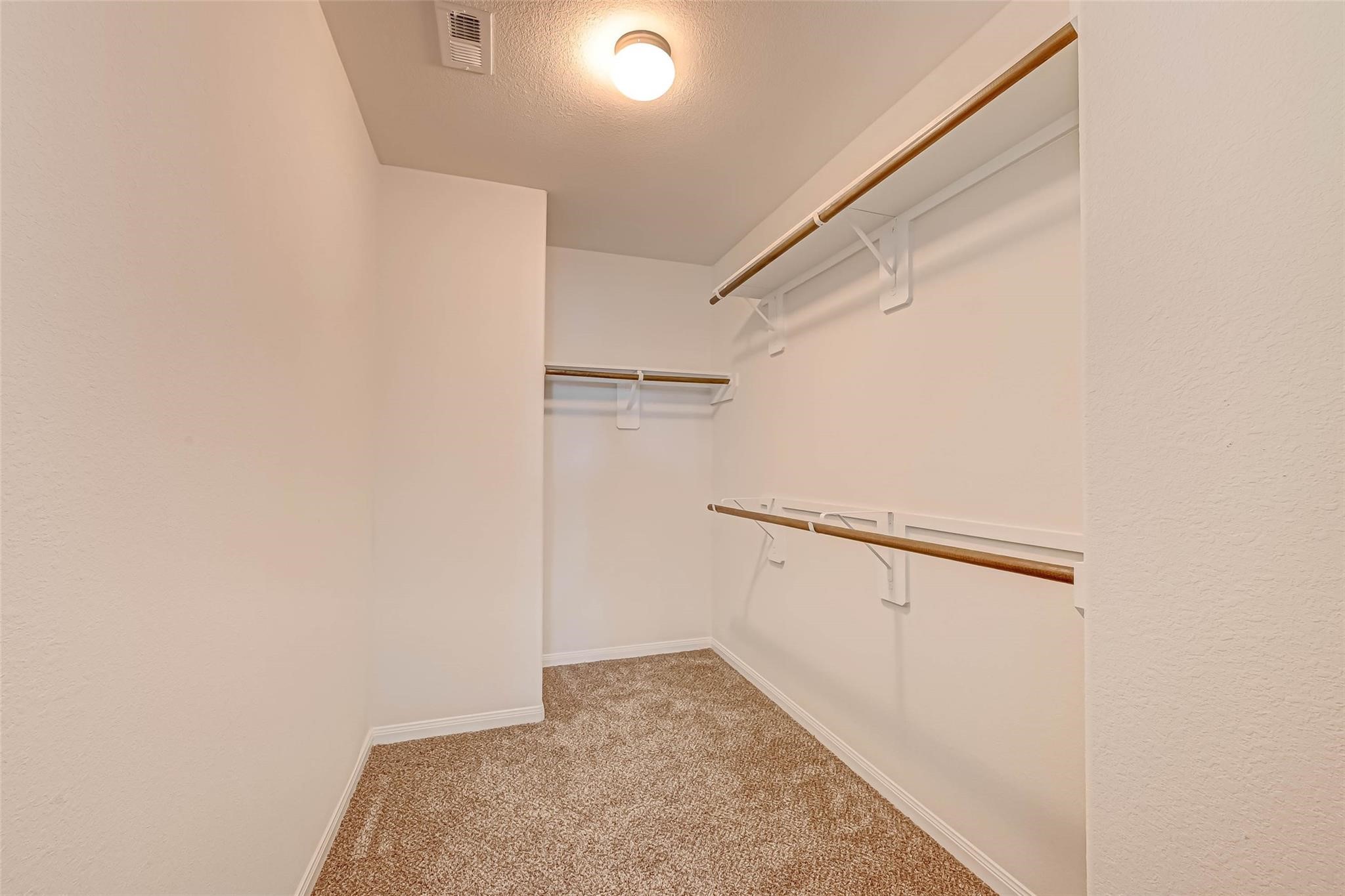 18606 Lansdowne Stream Path Katy, TX 77449 - Photo 32 of 39 a view of walk in closet with empty racks