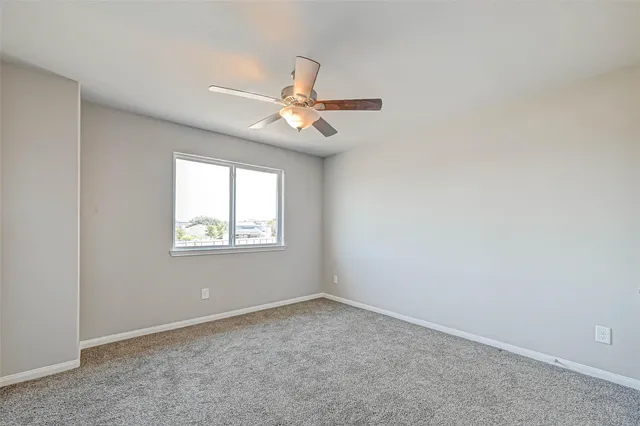 an empty room with closet and a chandelier fan