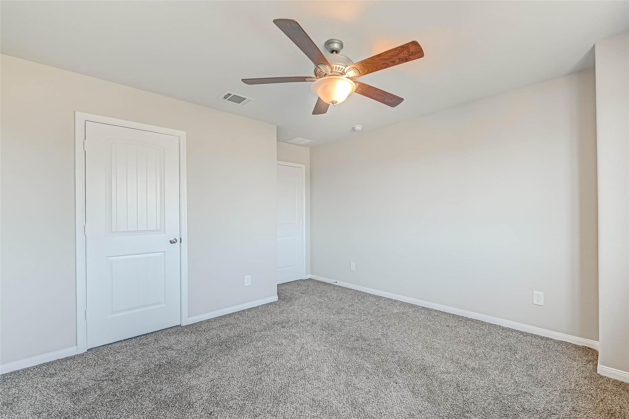18606 Lansdowne Stream Path Katy, TX 77449 - Photo 35 of 39 an empty room with closet and a chandelier fan